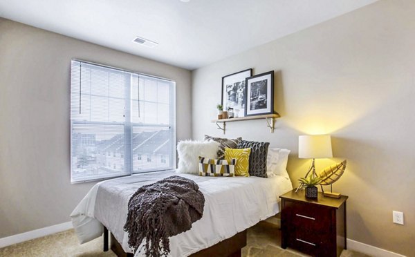 Spacious bedroom with modern decor at The Langston Apartments in Charlotte, perfect for luxury living