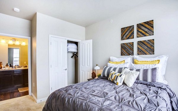 Cozy bedroom with modern furnishings at The Langston Apartments, ideal for luxury living in a Greystar-managed community