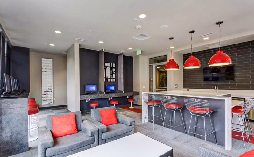 Contemporary clubhouse with study area at The Langston Apartments, featuring sleek design and ample workspace for residents