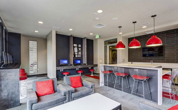 Contemporary clubhouse with study area at The Langston Apartments, featuring sleek design and ample workspace for residents