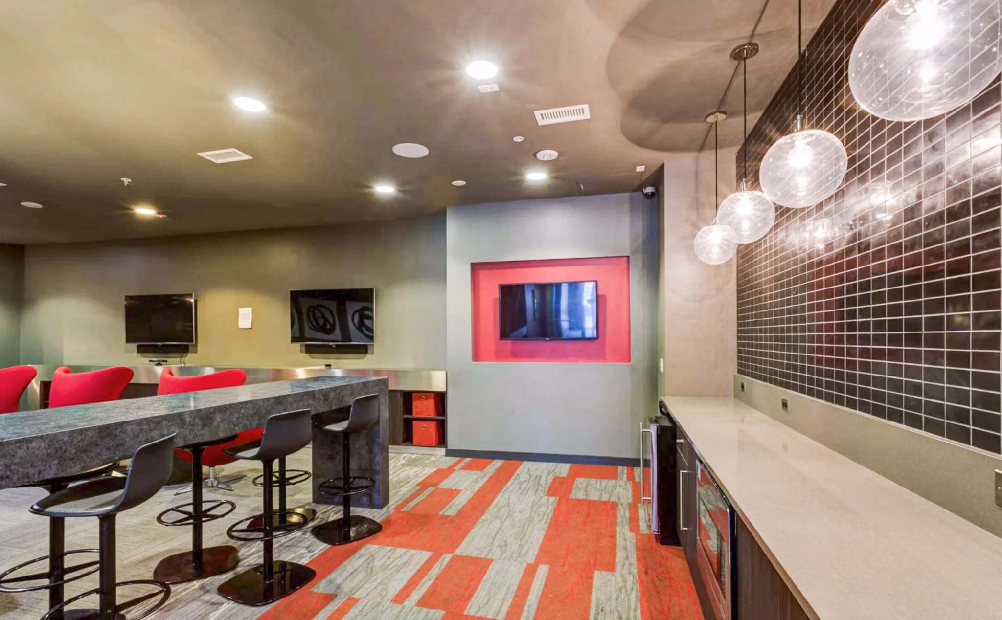 Clubhouse study area with modern furnishings at The Langston Apartments, perfect for luxury living