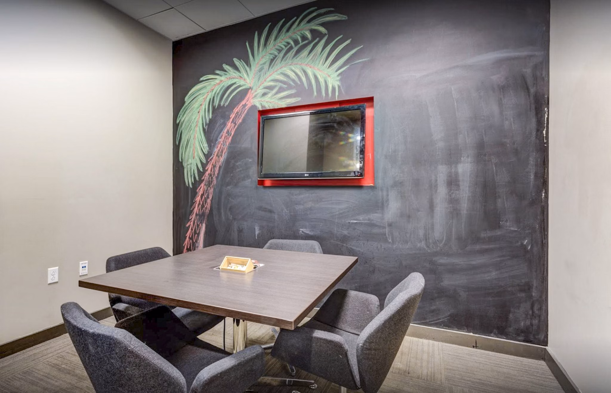 The Langston Apartments: Modern study area with sleek furniture and ample lighting, perfect for focused work or group study sessions