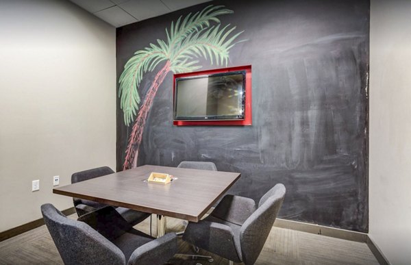 The Langston Apartments: Modern study area with sleek furniture and ample lighting, perfect for focused work or group study sessions