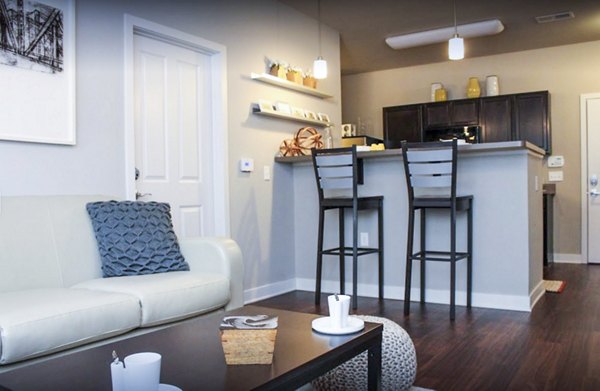 Spacious living room with elegant furnishings at The Langston Apartments