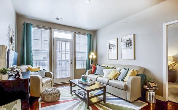 Spacious living room with contemporary decor at The Langston Apartments