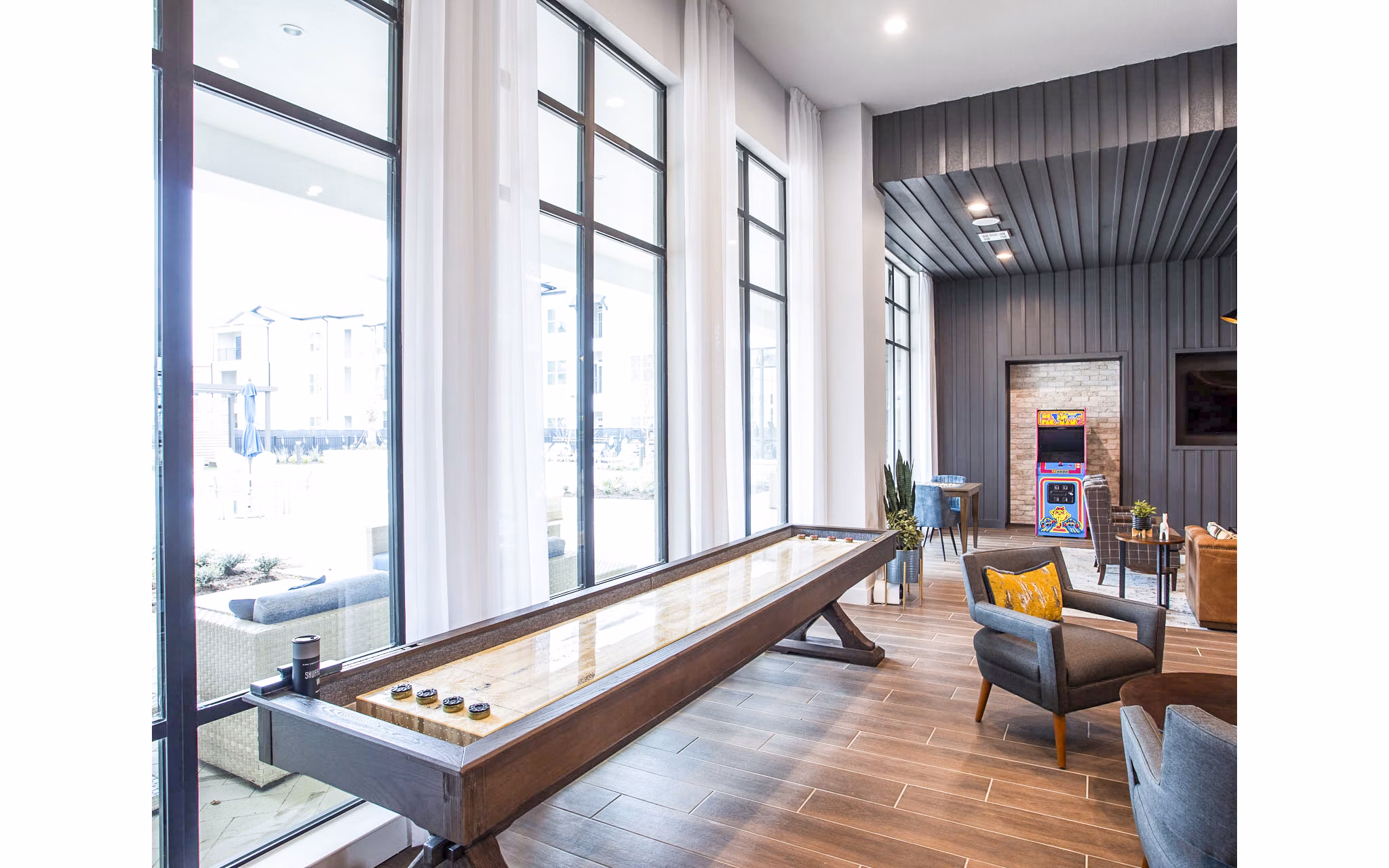 Clubhouse game room with pool table and seating at Broadstone North Ridge Apartments