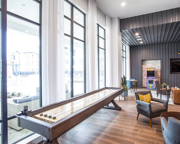 Clubhouse game room with pool table and seating at Broadstone North Ridge Apartments