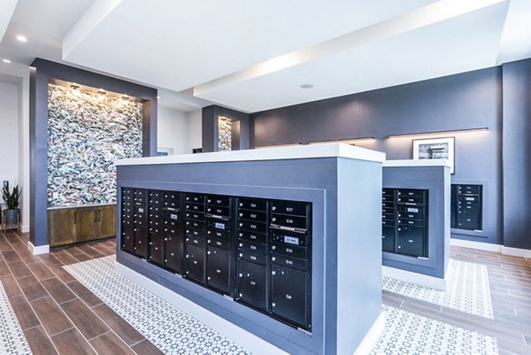 Clubhouse mail room at Broadstone North Ridge Apartments with secure parcel lockers and guest seating area