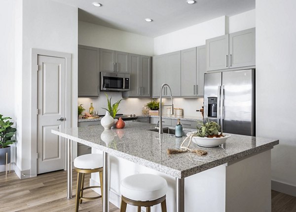 Modern kitchen featuring sleek appliances and granite countertops at Broadstone North Ridge Apartments