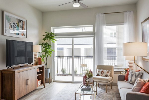 Spacious living room with modern furnishings and large windows in Broadstone North Ridge Apartments