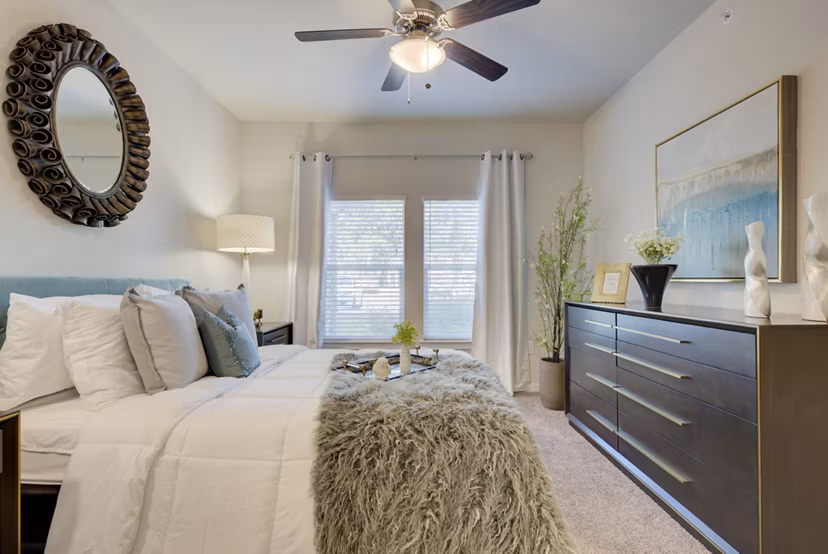 Bedroom featuring modern design and ample natural light in Roots at O'Connor Apartments