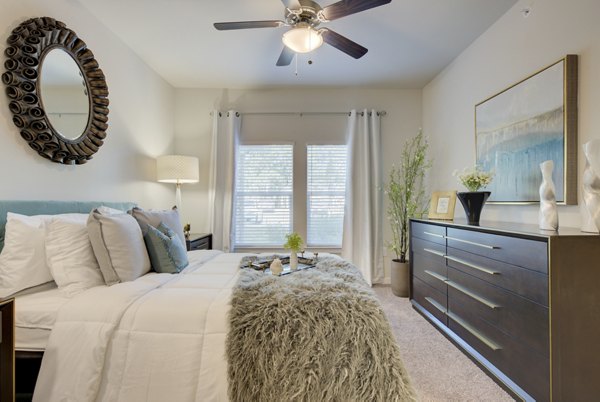Bedroom featuring modern design and ample natural light in Roots at O'Connor Apartments