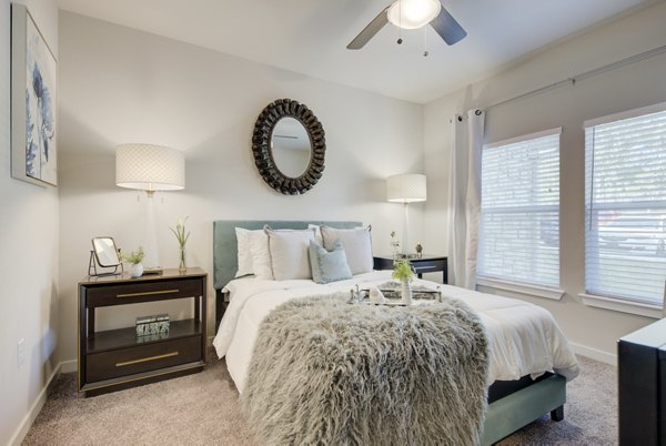 Cozy bedroom with contemporary furnishings at Roots at O'Connor Apartments
