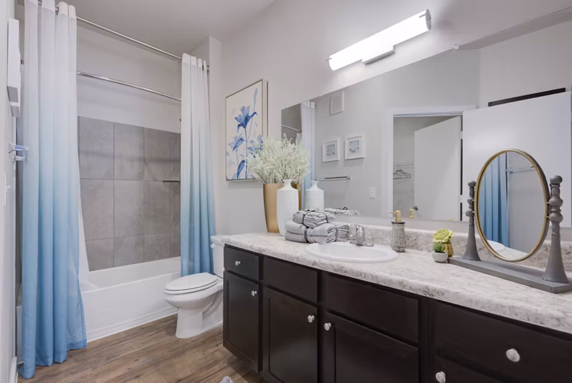 Modern bathroom with sleek fixtures at Roots at O'Connor Apartments, featuring stylish tile work and ample lighting for a luxurious experience