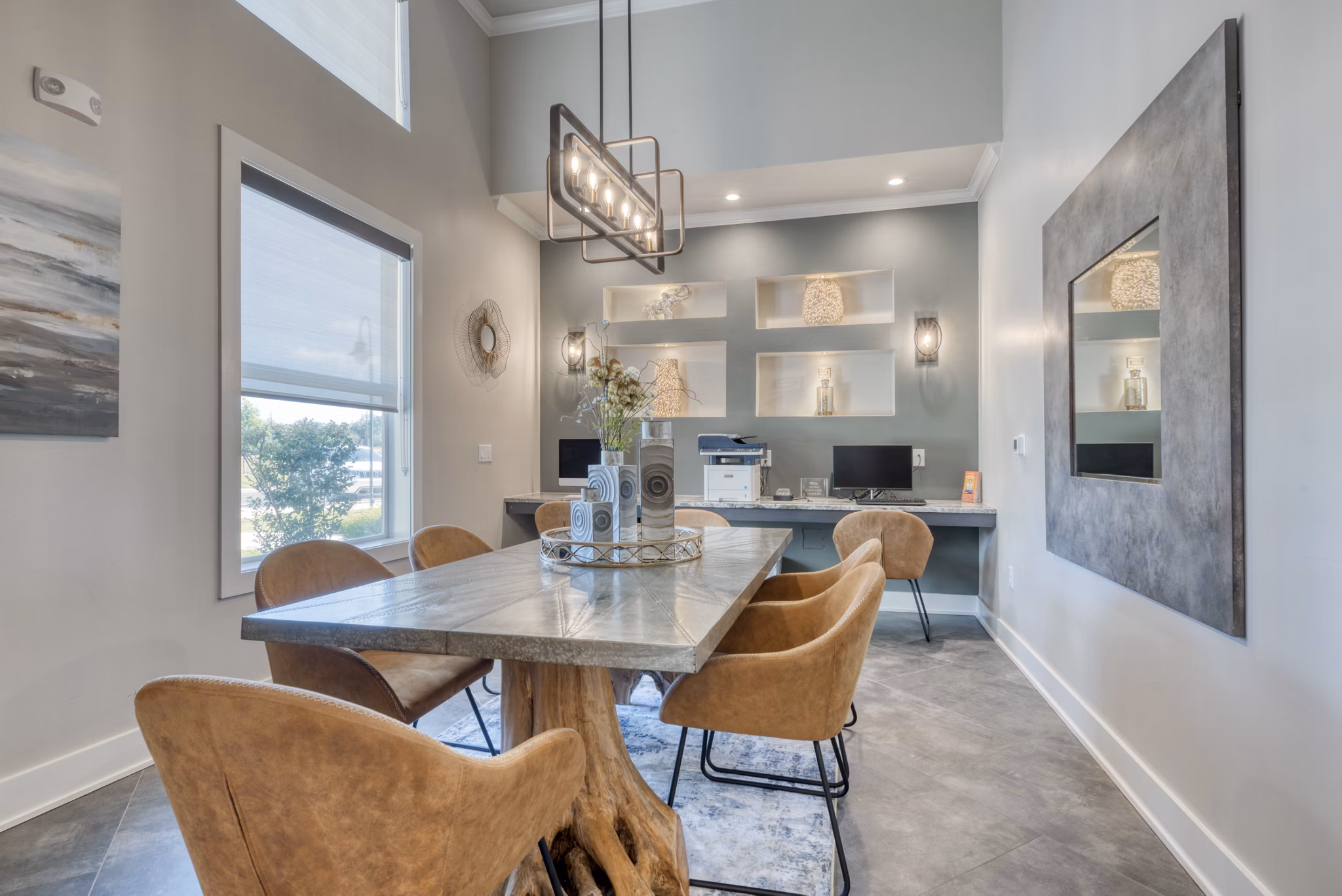 Business center with modern workstations at Roots at O'Connor Apartments, ideal for remote working and collaboration in a luxury setting