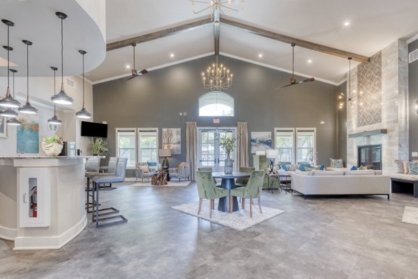 Modern clubhouse with stylish seating and fireplace at Roots at O'Connor Apartments