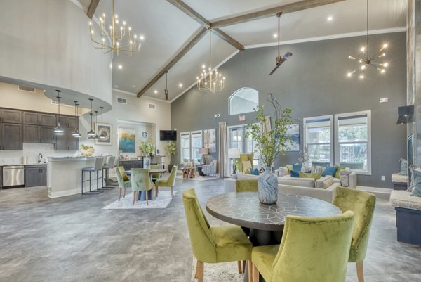 Modern clubhouse featuring cozy seating and entertainment options at Roots at O'Connor Apartments
