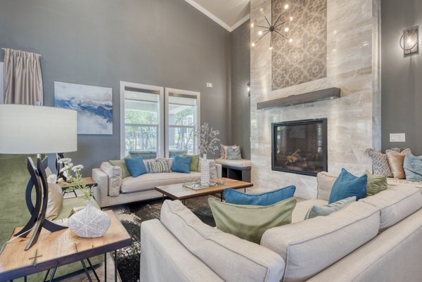 Modern clubhouse with lounge seating at Roots at O'Connor Apartments, offering residents luxurious amenities and social space