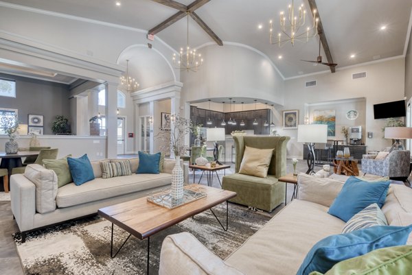 Clubhouse featuring modern design and cozy seating at Roots at O'Connor Apartments