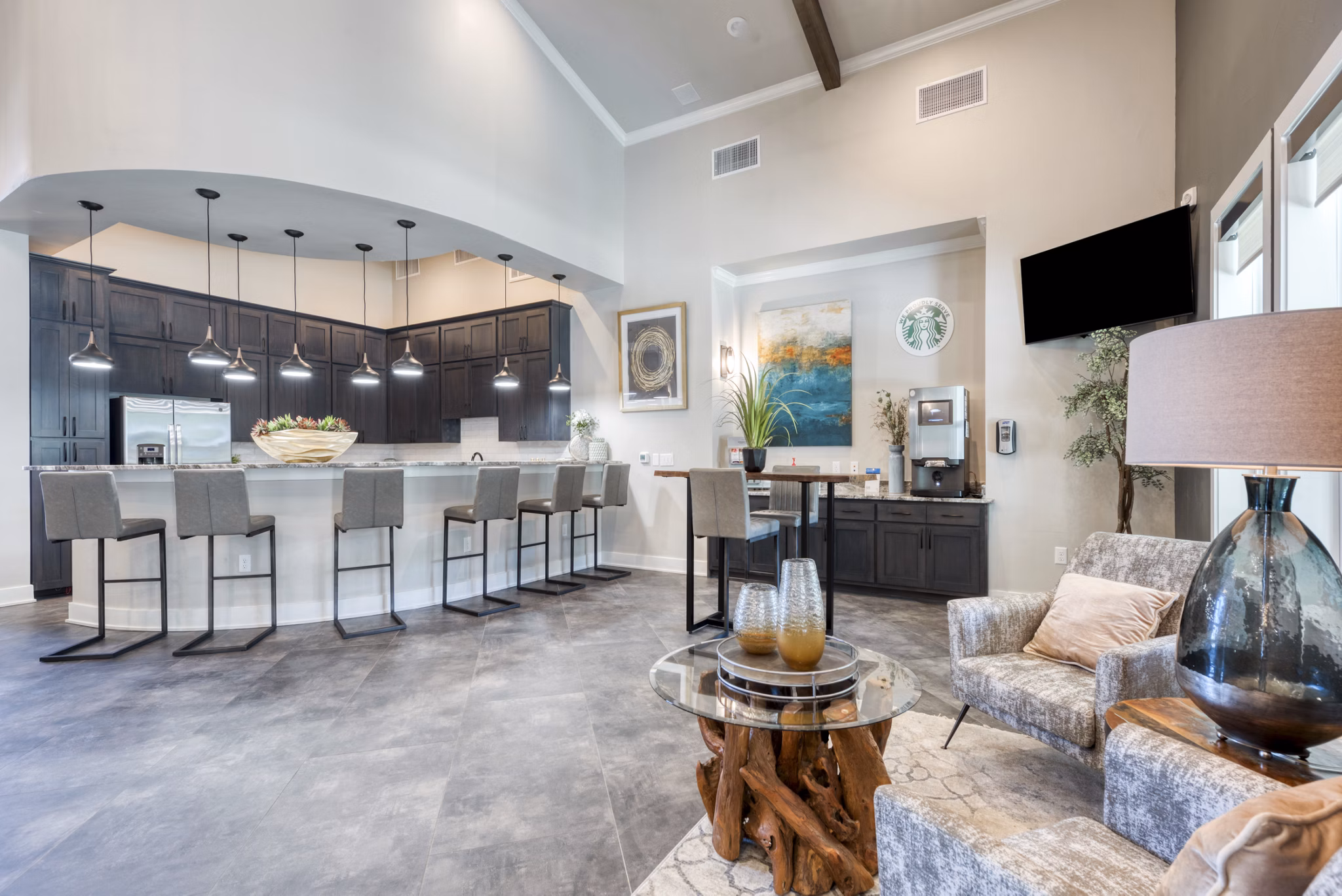 Clubhouse with modern design at Roots at O'Connor Apartments featuring cozy seating areas and vibrant decor, perfect for social gatherings