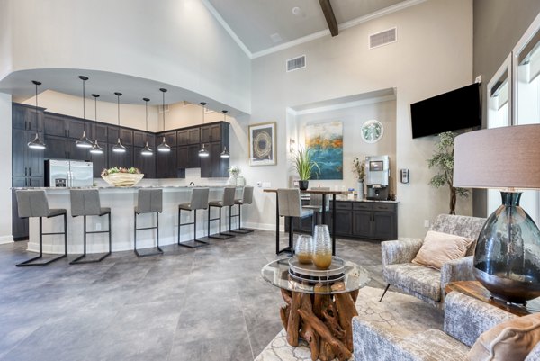 Clubhouse with modern design at Roots at O'Connor Apartments featuring cozy seating areas and vibrant decor, perfect for social gatherings
