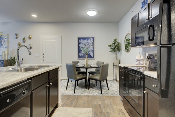 Bright kitchen with modern appliances at Roots at O'Connor Apartments, showcasing contemporary design Perfect for luxury living in a Greystar property