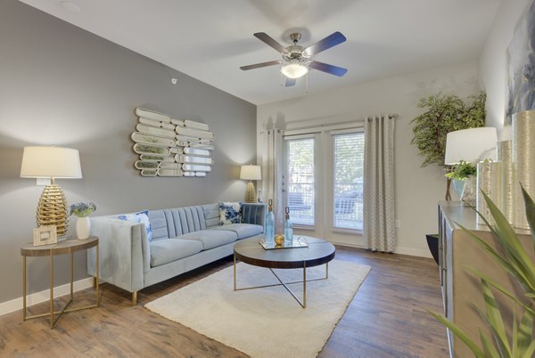 Spacious living room with modern decor in Roots at O'Connor Apartments
