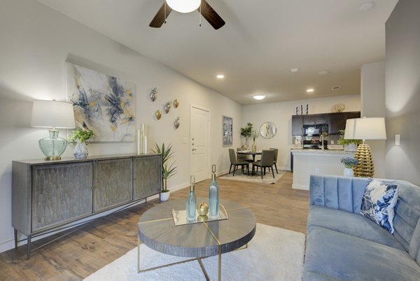Spacious living room with contemporary furnishings in Roots at O'Connor Apartments, a luxury property by Greystar