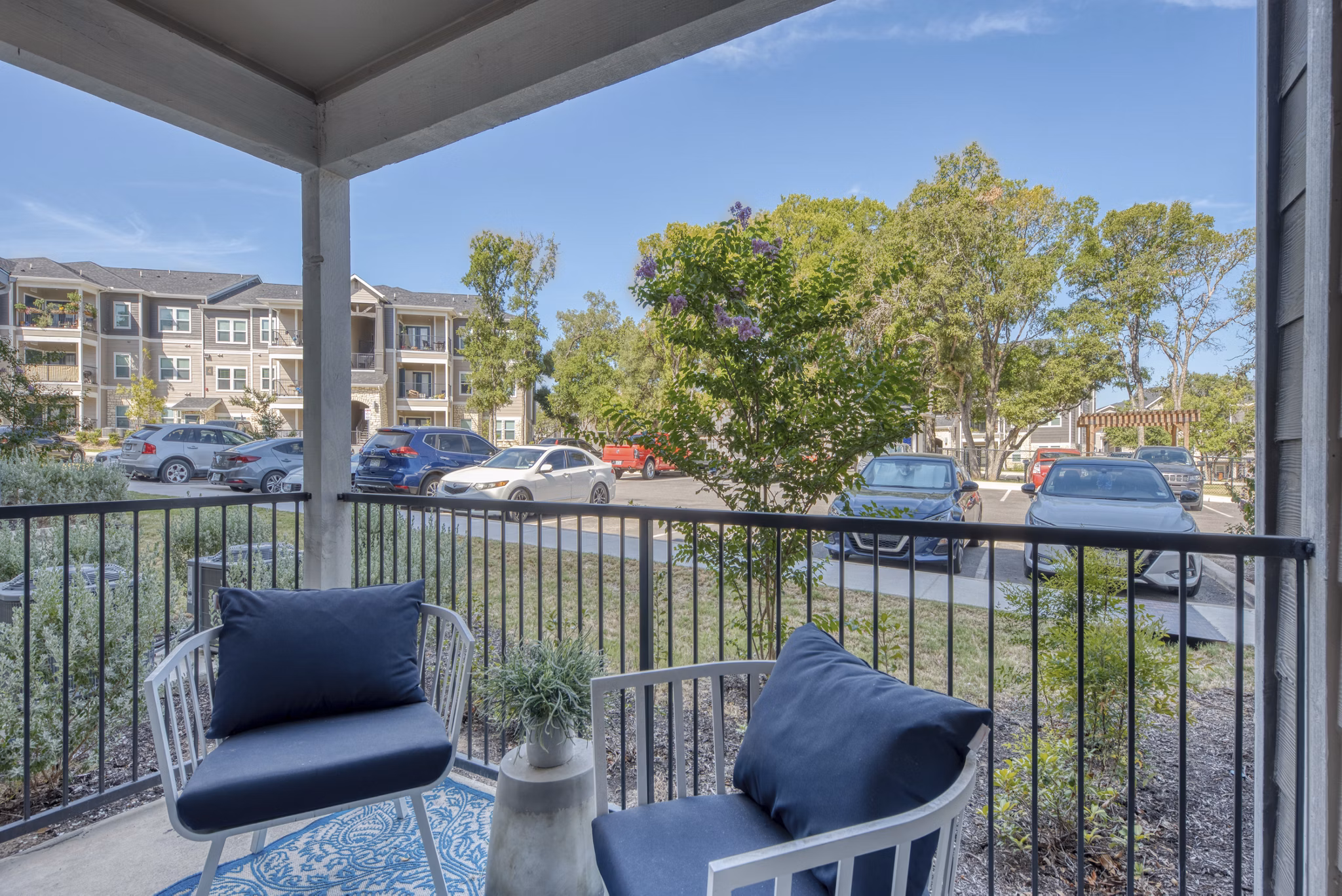 Patio area featuring comfortable seating and lush greenery at Roots at O'Connor Apartments Perfect for relaxation and social gatherings