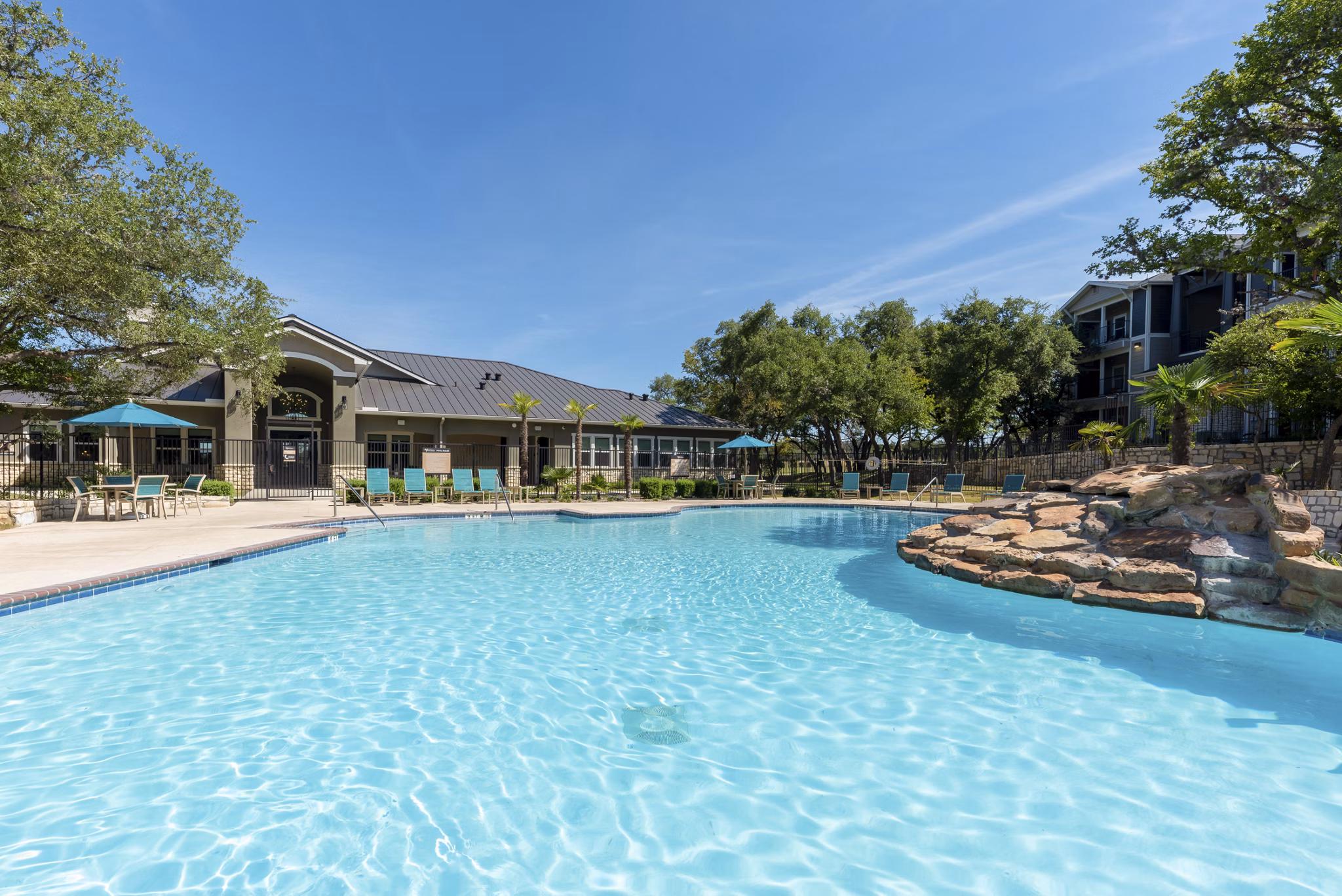 Outdoor pool with lounging area at Roots at O'Connor Apartments