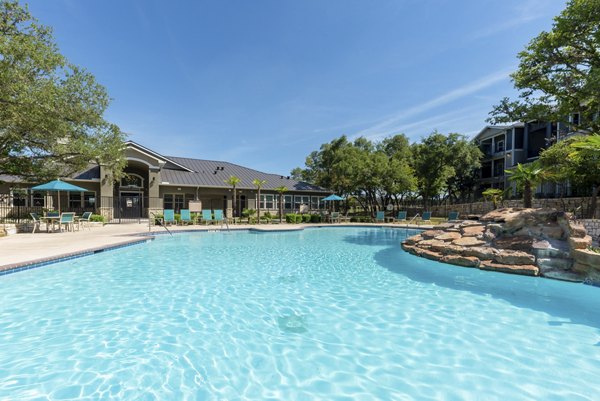 Outdoor pool with lounging area at Roots at O'Connor Apartments