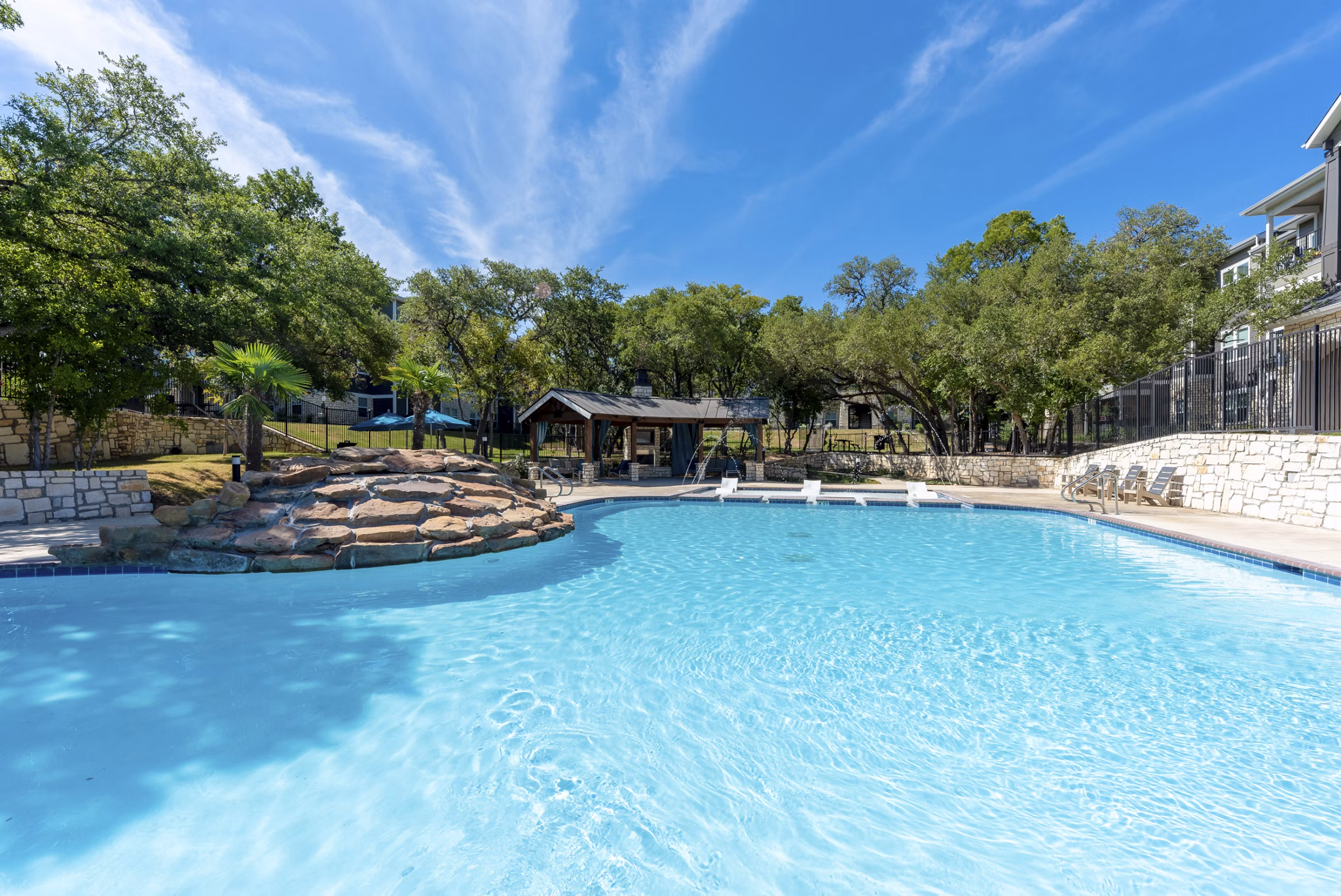 Rooftop pool with skyline views at Roots at O'Connor Apartments