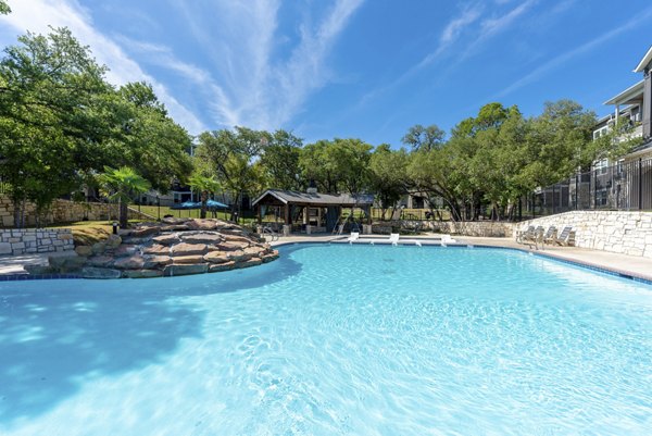 Rooftop pool with skyline views at Roots at O'Connor Apartments