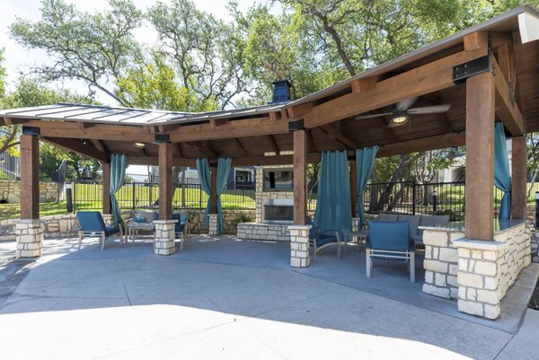 Cozy outdoor fire pit area at Roots at O'Connor Apartments, perfect for relaxation and social gatherings under starry skies