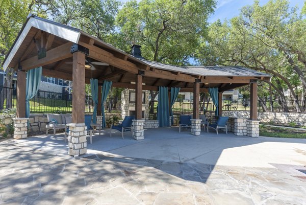 Cozy fire pit area at Roots at O'Connor Apartments, perfect for evening gatherings