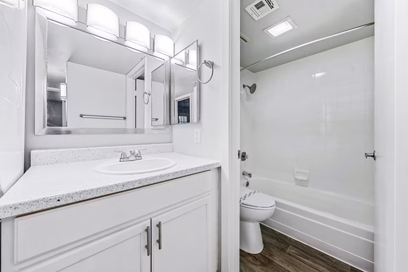 Modern bathroom with marble countertops at Villatree Apartments, refined design offering luxury living in an inviting atmosphere