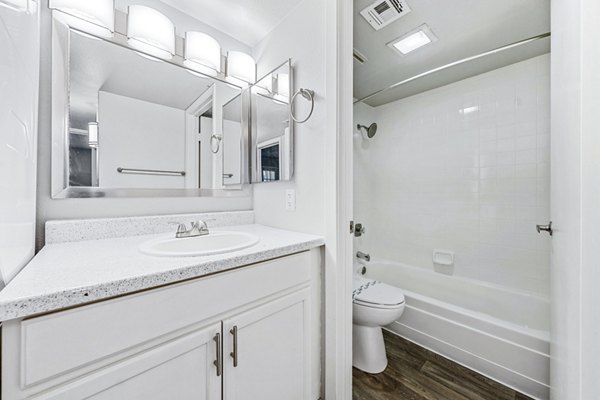 Modern bathroom with marble countertops at Villatree Apartments, refined design offering luxury living in an inviting atmosphere