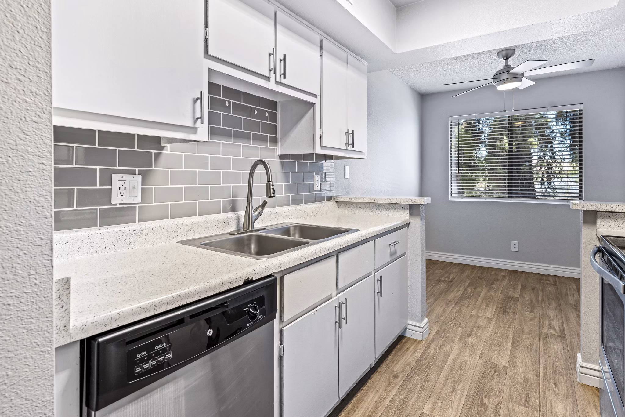 Modern kitchen with stainless steel appliances at Villatree Apartments