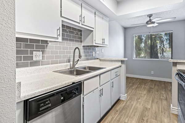 Modern kitchen with stainless steel appliances at Villatree Apartments