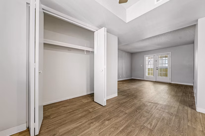 Spacious living room with modern decor and floor-to-ceiling windows in Villatree Apartments
