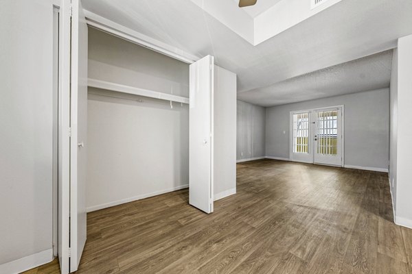Spacious living room with modern decor and floor-to-ceiling windows in Villatree Apartments