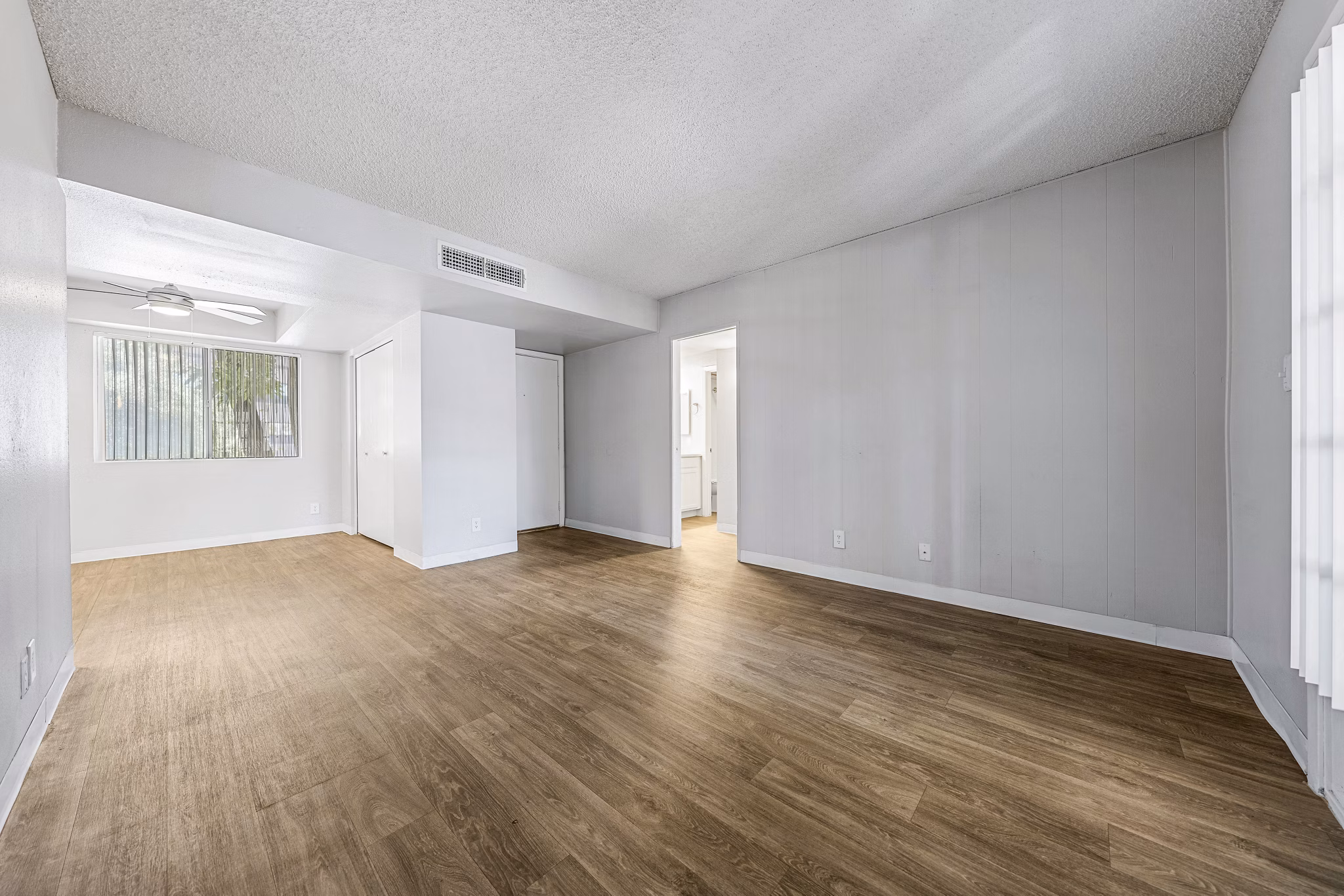 Spacious living room with modern decor in Villatree Apartments