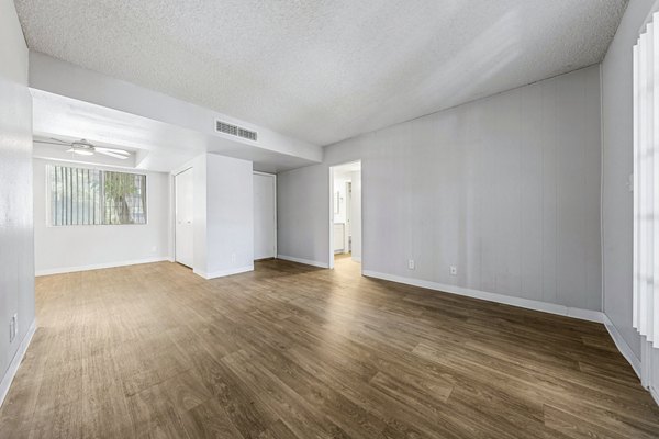 Spacious living room with modern decor in Villatree Apartments