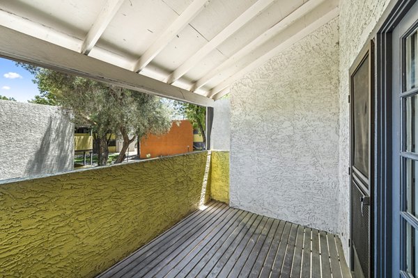 Sunny balcony with modern seating at Villatree Apartments, perfect for leisure and relaxation