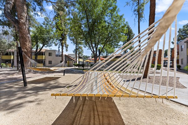 Hammock and patio area at Villatree Apartments offering relaxing outdoor living space