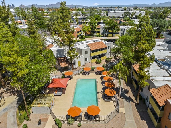 Relaxing pool with sun loungers at Villatree Apartments offering luxury living in a serene environment, ideal for leisure and recreation