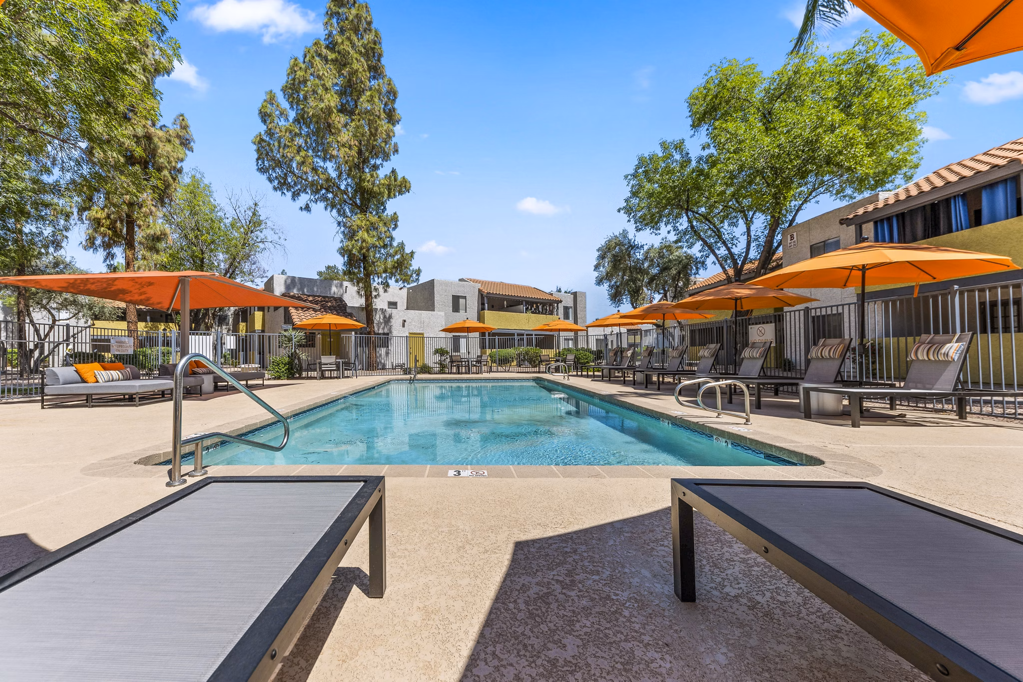 Inviting outdoor pool area at Villatree Apartments offering relaxation and leisure with modern design elements