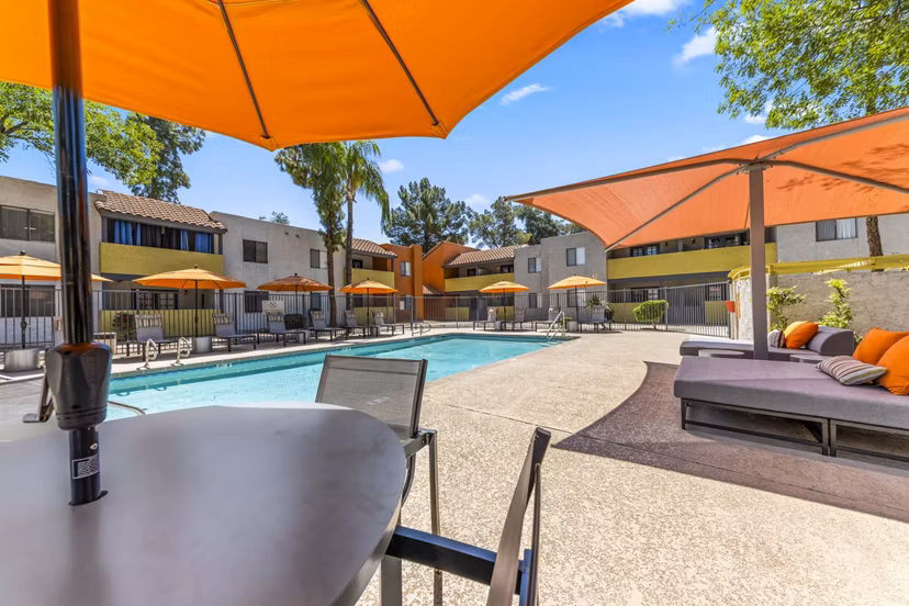 Resort-style pool with sun loungers at Villatree Apartments, ideal for relaxation and leisure