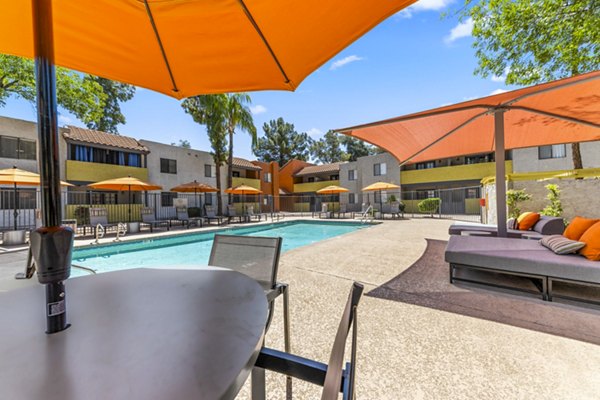 Resort-style pool with sun loungers at Villatree Apartments, ideal for relaxation and leisure