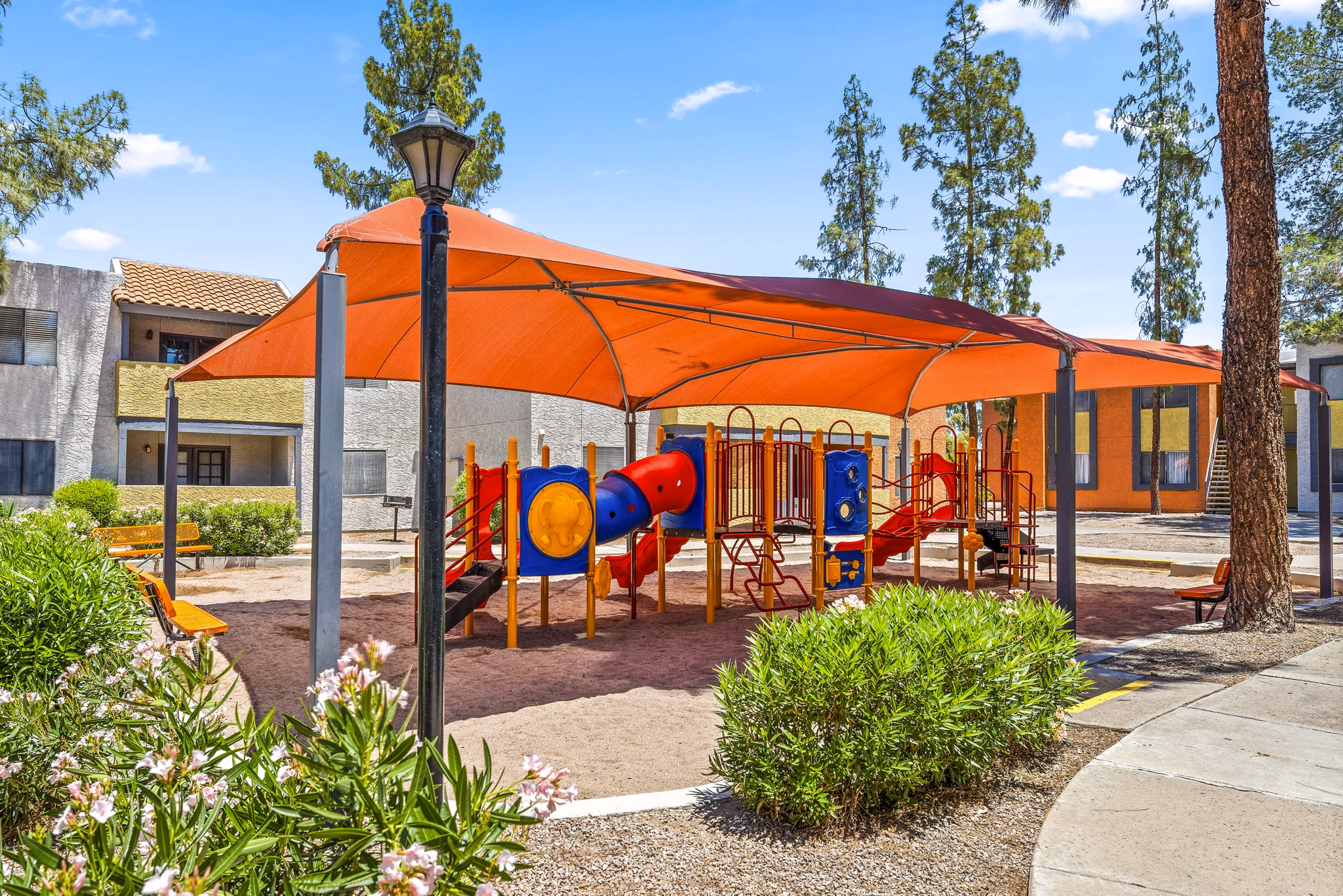 Modern playground with slides and swings at Villatree Apartments, offering family-friendly outdoor spaces